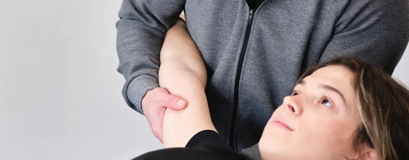 Patiënt krijgt fysiotherapie behandeling voor elleboogpijn